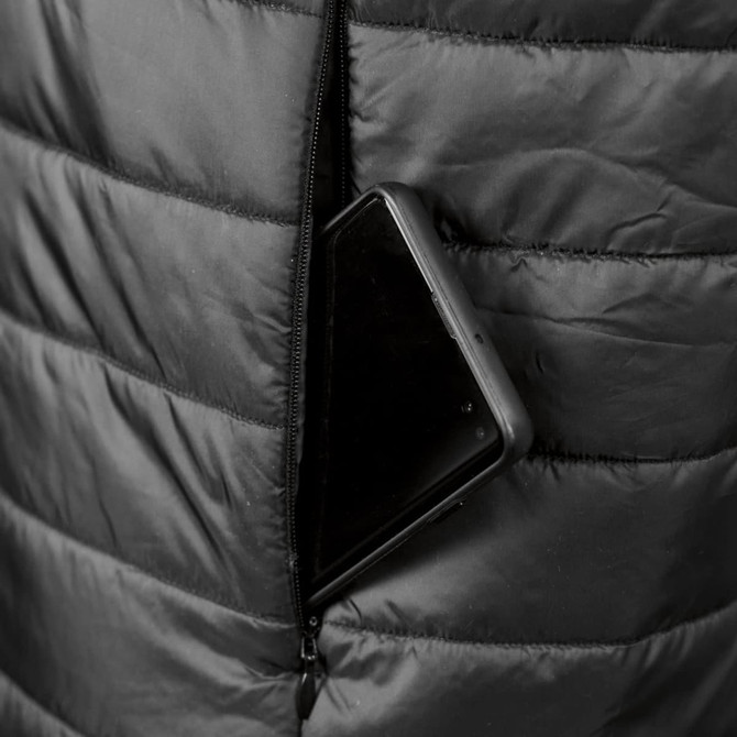 A black puffer vest with a smartphone partially tucked into a zippered pocket. The fabric features a quilted design.