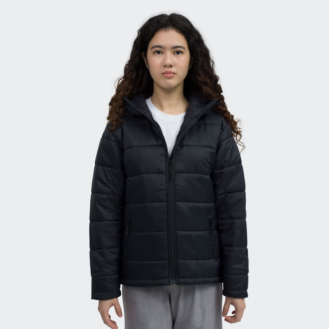 A black puffer jacket with a zip front and a hood, worn by a model with curly hair. The jacket features a logo.