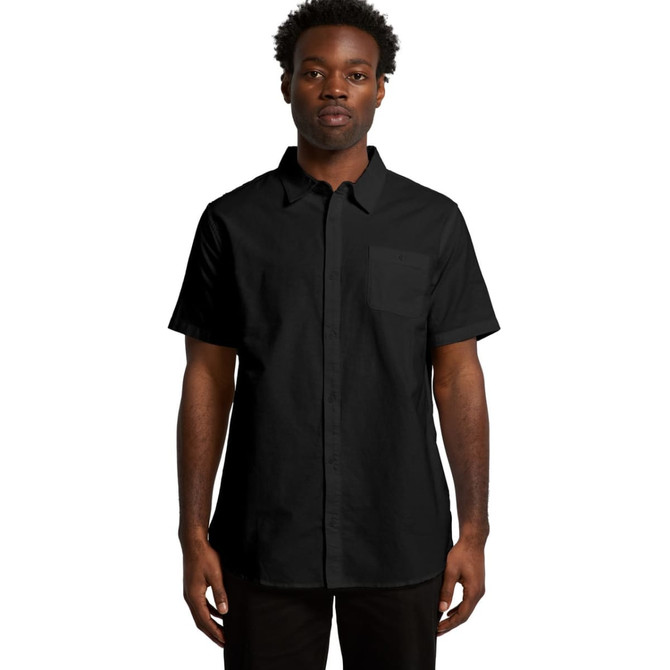 A black short-sleeve button-up shirt with a single chest pocket and a logo.