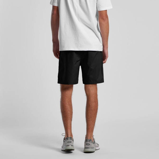 Black beach shorts with an elastic waistband, featuring side pockets and a branding logo.