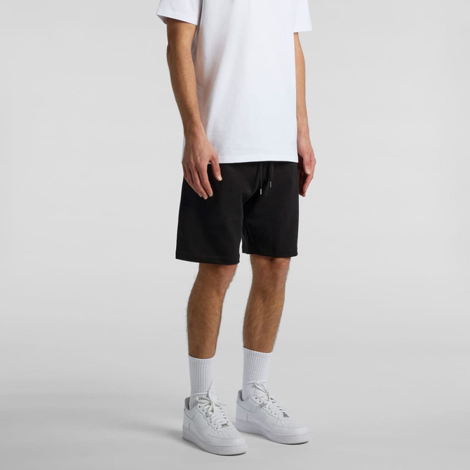 Black sports shorts with a drawstring, featuring a logo, worn with a white T-shirt and white sneakers.