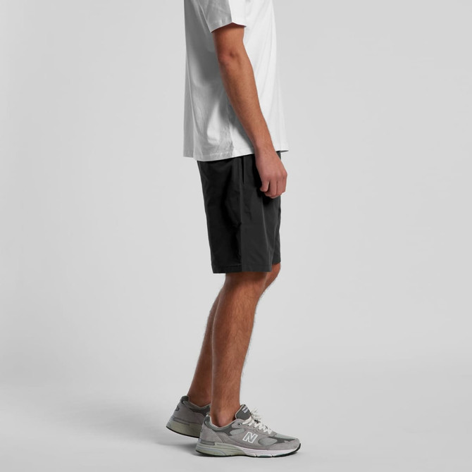 Active training shorts in black, featuring a streamlined design, worn by a person in grey sneakers and a white t-shirt.