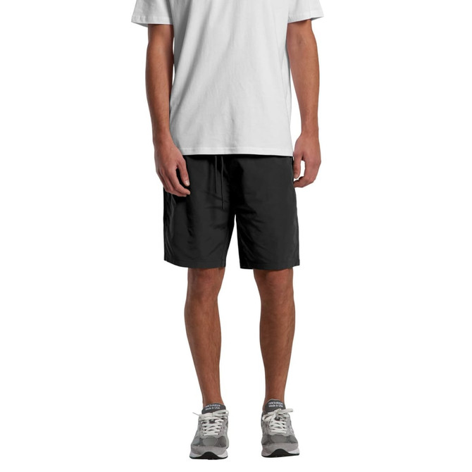 Active training shorts in black, featuring a logo, styled with a grey T-shirt and grey trainers.