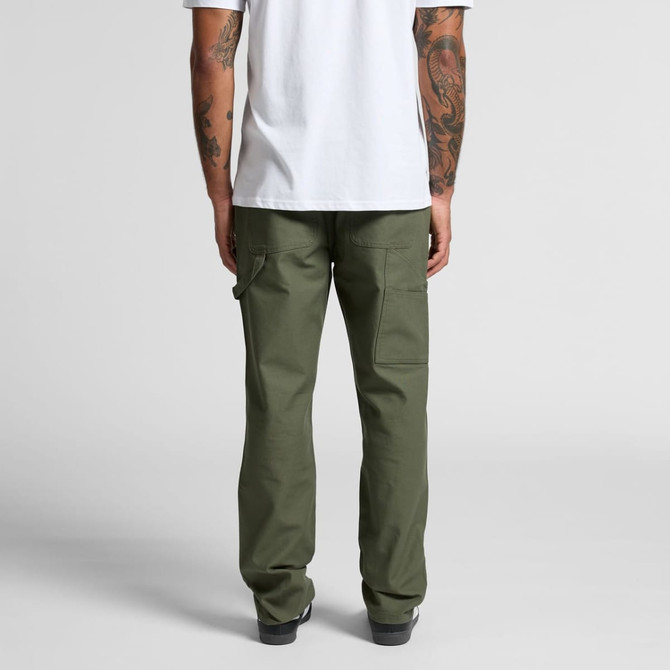 Utility pants in olive green, featuring multiple pockets. The model stands with their back towards the camera.