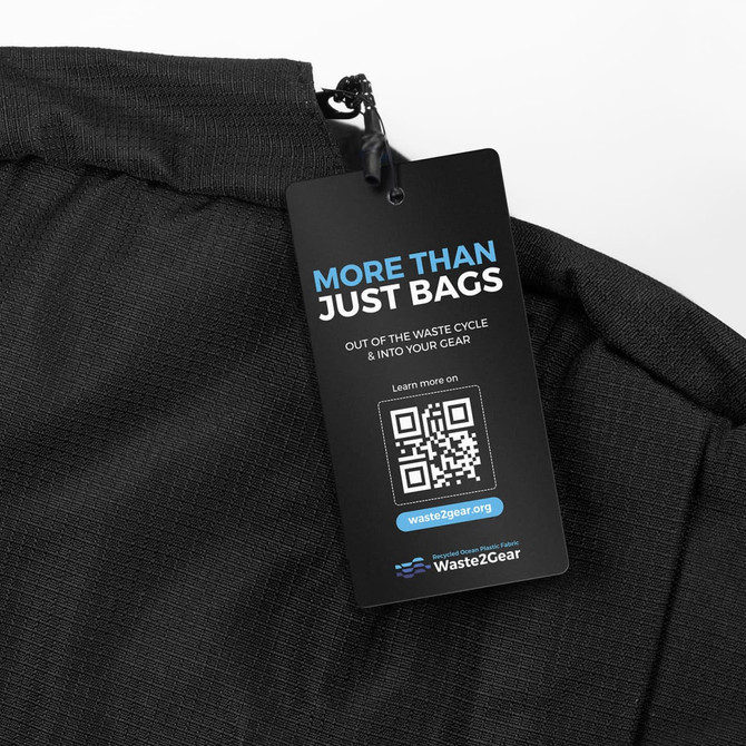 A black computer bag with a textured surface and a promotional tag attached. The tag has a QR code and branding.