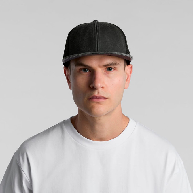 A grey trucker cap with a structured front and mesh back, worn by a model in a white t-shirt.