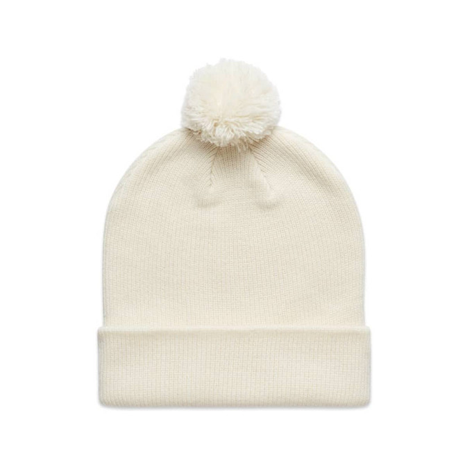 A cream Pom Pom Beanie with a fluffy pom pom on top and a folded cuff, featuring a logo on the side.