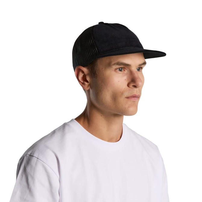 A man wearing a black trucker cap with a mesh back, paired with a white T-shirt. The cap features a logo.