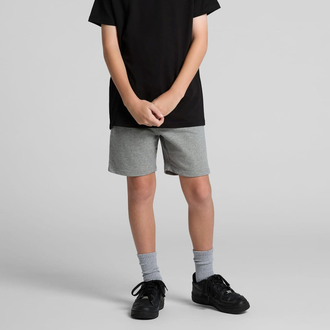 Grey youth stadium shorts with an elastic waistband, styled with a black t-shirt and black sneakers.