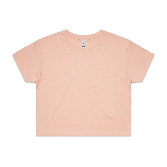 A cropped tee in a soft peach colour with a relaxed fit and short sleeves. It features a branding label.