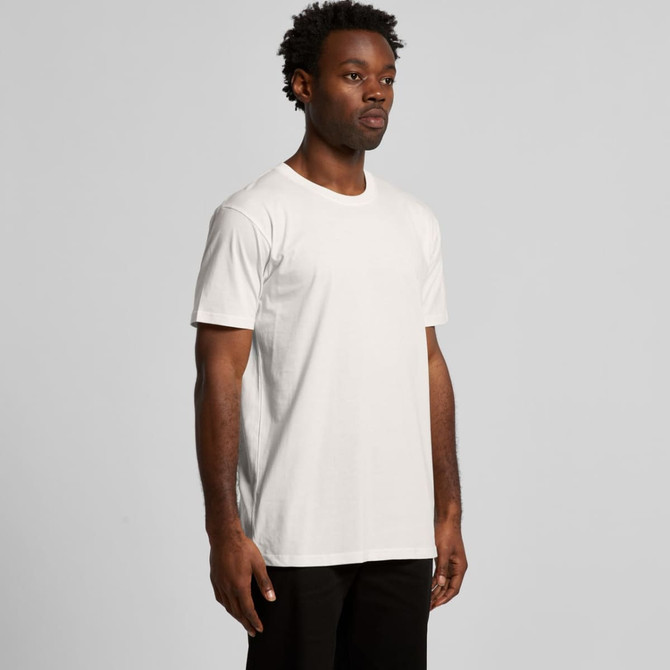 A model wearing a plain white organic t-shirt. The shirt has a subtle logo on it and a simple design.