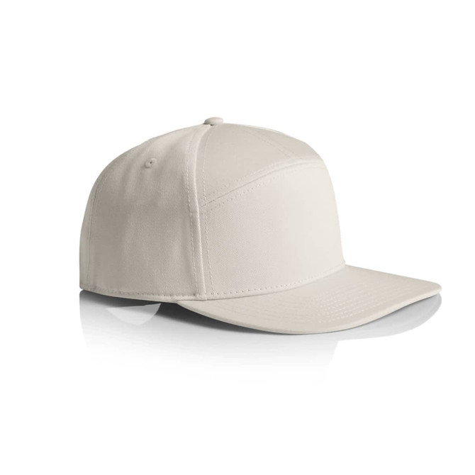 A 7-panel cap in a light cream colour, featuring a structured design and a curved brim. It has a logo on the side.