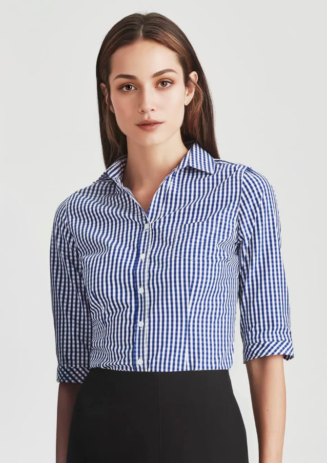 A fitted women's button-up shirt with 3/4 sleeves in a blue and white gingham pattern, featuring a collar and buttons.