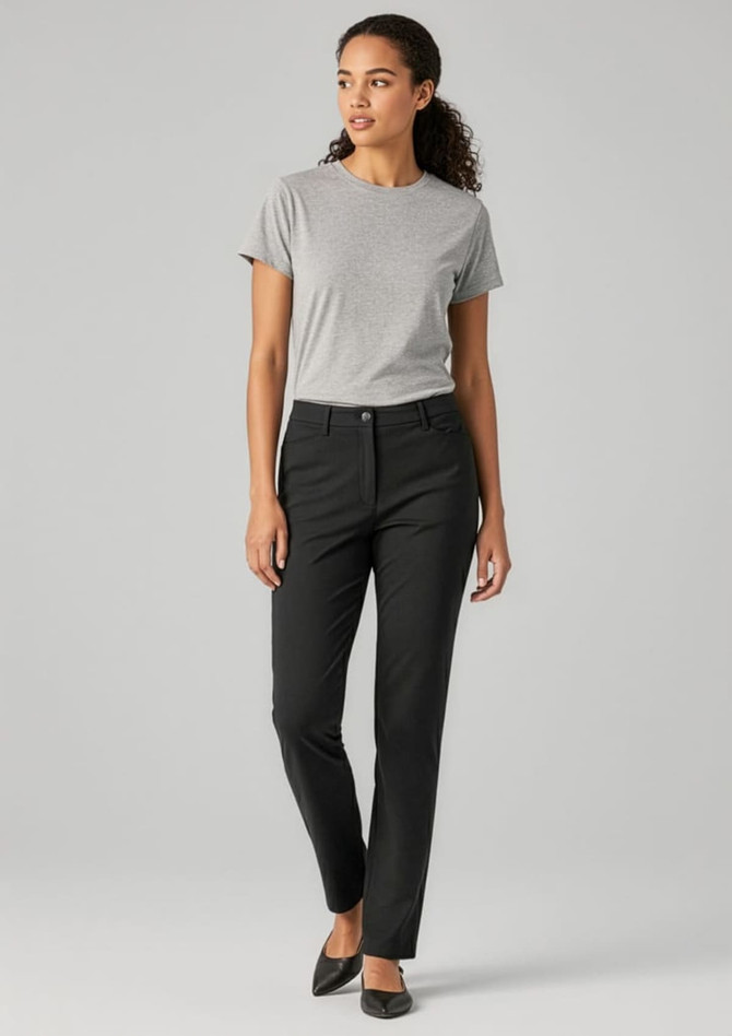 A woman wearing black slacks and a grey t-shirt, standing against a neutral background. The pants feature a subtle logo.