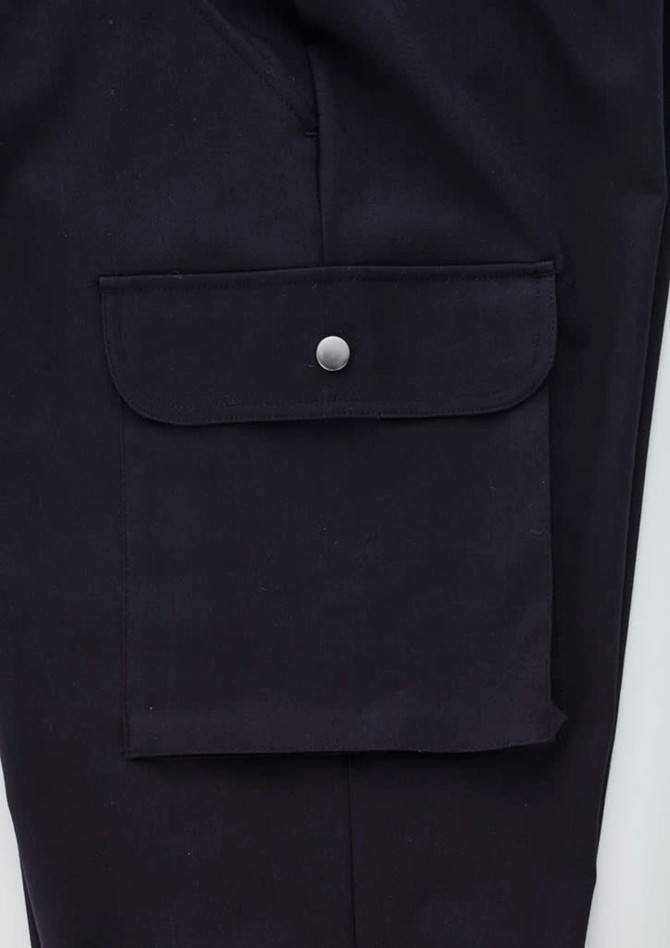 A pair of black cargo pants featuring a large side pocket with a snap closure and a smooth fabric finish.