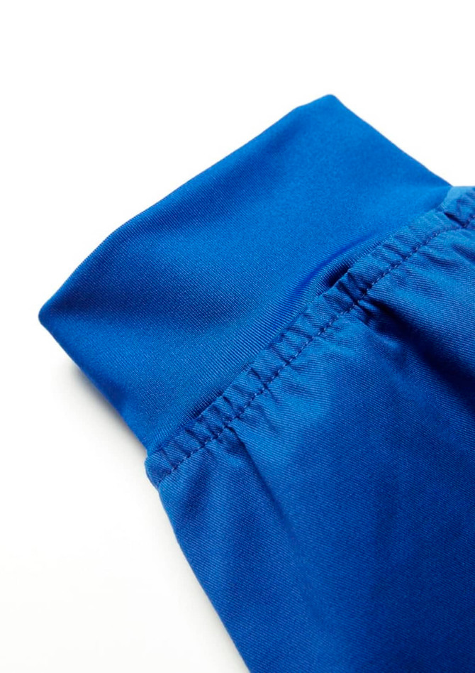 A pair of blue jogger scrub pants featuring a fitted waistband and elastic details.