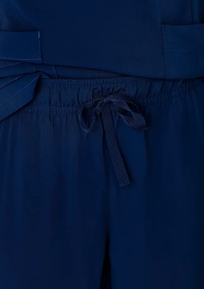 Navy blue women's straight leg scrub pants featuring a drawstring waist and pockets. Branding is present on the fabric.