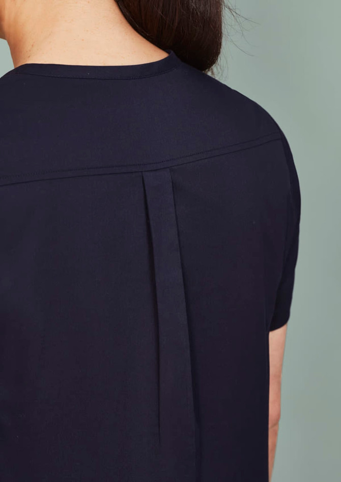 A women's rose tunic scrub top, featuring a sleek design with a pleat detail at the back. The fabric is dark navy.