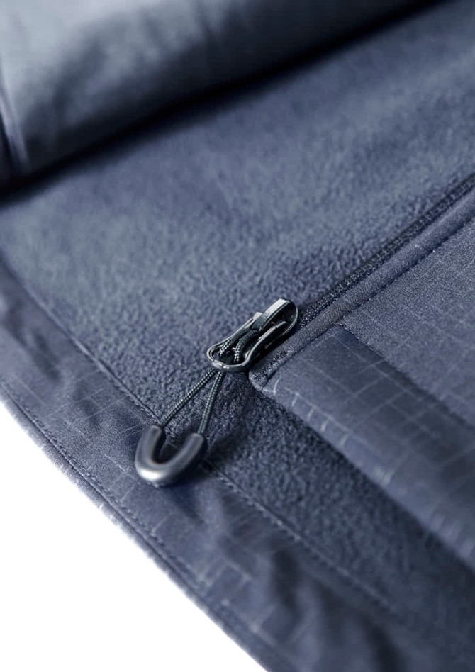 A close-up of a navy soft shell jacket featuring a zip and a hook. The material has a textured pattern.