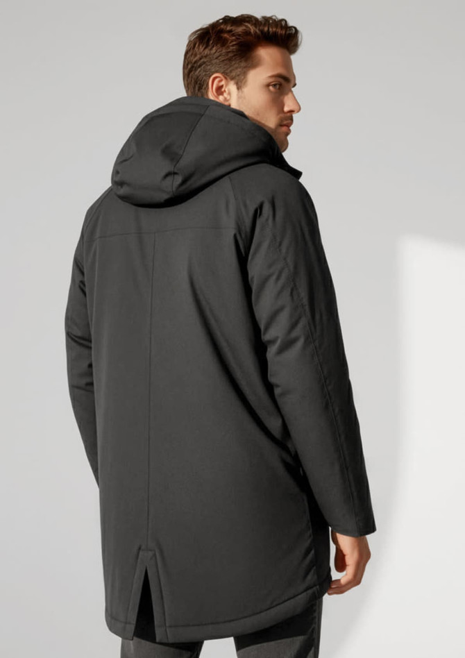 A man in a black unisex rain jacket with a hood, featuring a simple design and a slight split at the back.