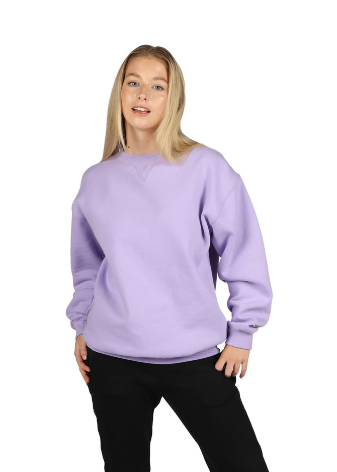 A model wearing a lavender-coloured poly cotton fleece sloppy joe sweater, paired with black pants.