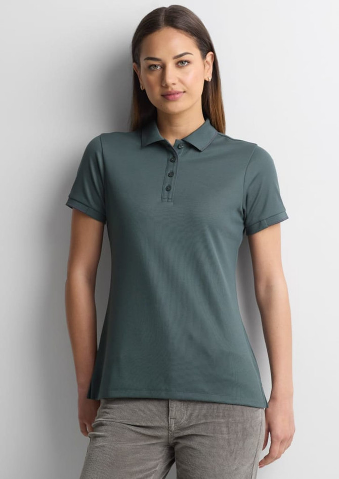 A women's short sleeve polo shirt in a teal colour, featuring a collar and buttons, with a logo on the chest.