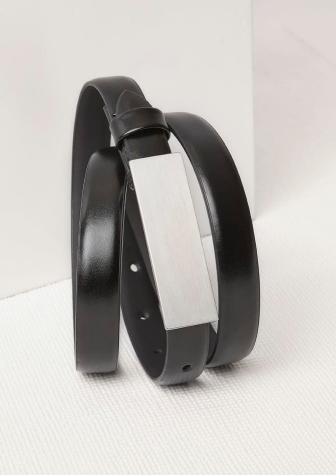 A black women's leather belt featuring a sleek silver buckle, arranged in a stylish twist.