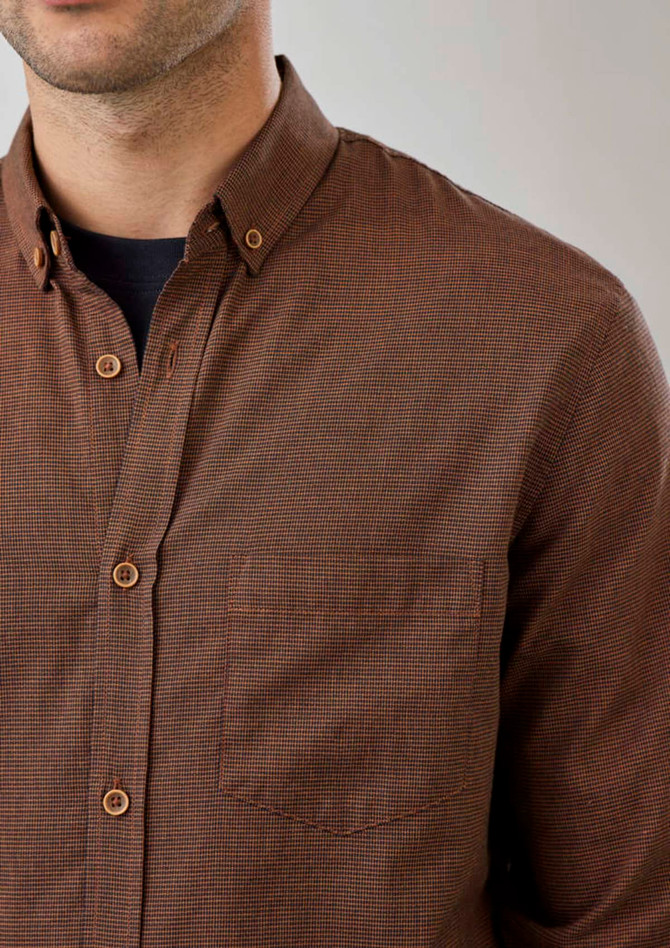 A brown button-up long sleeve shirt featuring a check pattern and a chest pocket. It has a logo on the label.