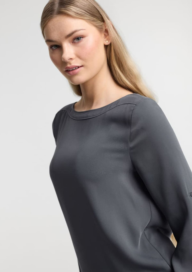 A grey women's boatneck top with long sleeves displayed on a model against a neutral background.