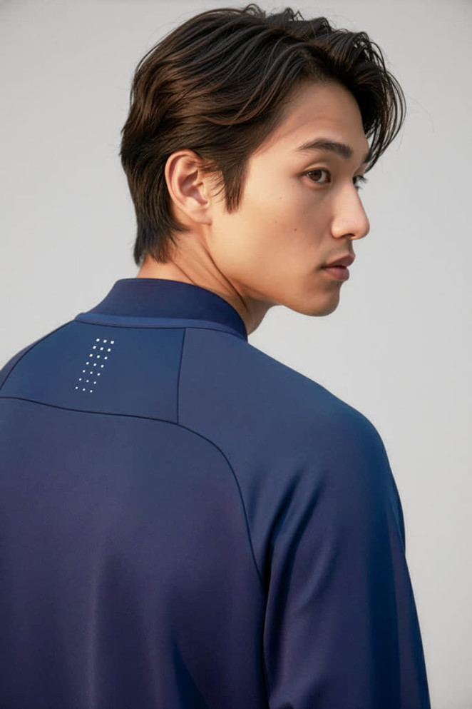 A navy unisex mid layer top with a simple design and a logo on the back collar.