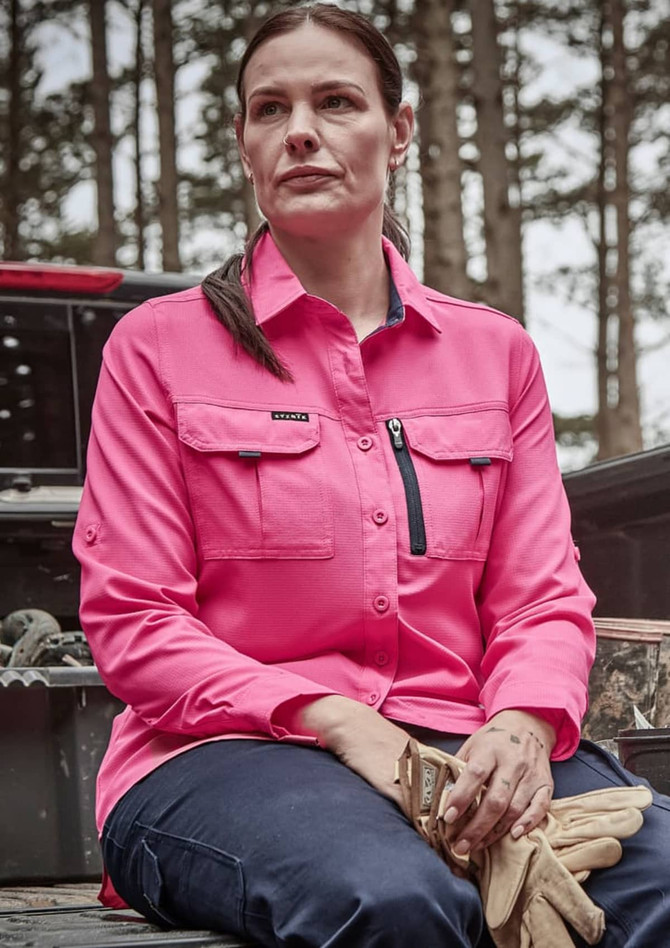 A long sleeve women's button-up shirt in bright pink with two front pockets and a zippered chest pocket.