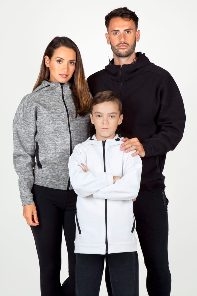 A pair of adults and a child wearing space hoodies in grey, black, and white, featuring zippers and a logo.