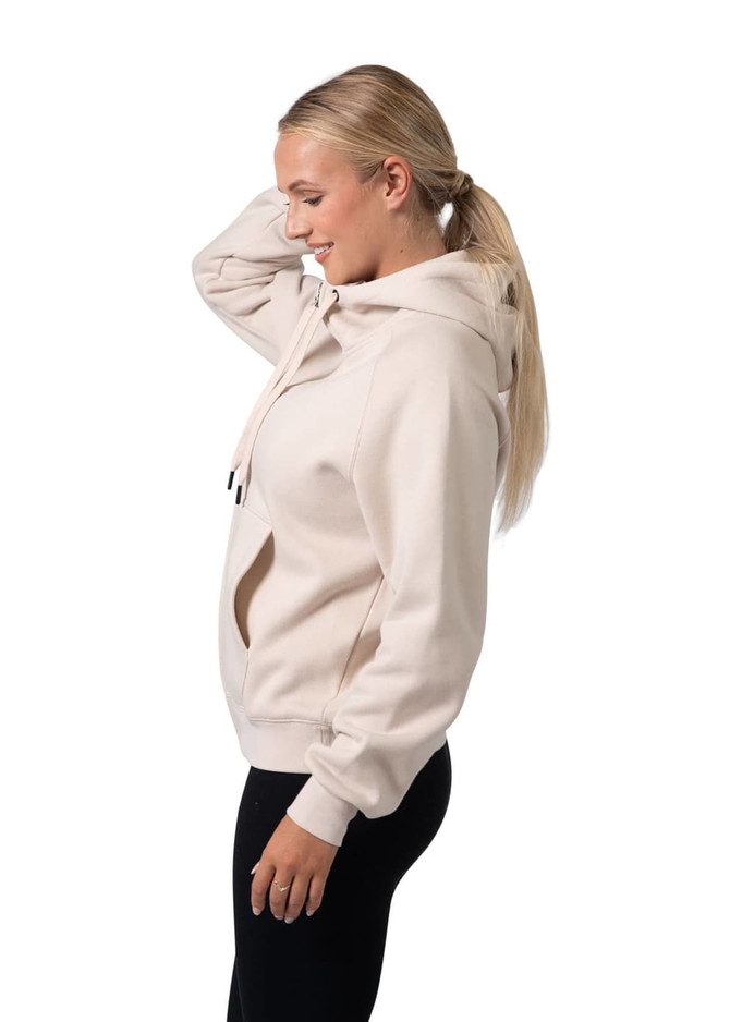 A women's cotton hoodie in light beige with a kangaroo pocket and a zipper, featuring a logo on the hood.