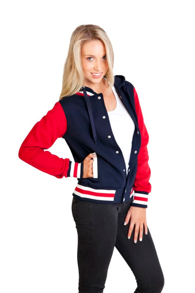 A women's varsity jacket in navy and red, featuring a hood and a logo, modelled with a casual pose.