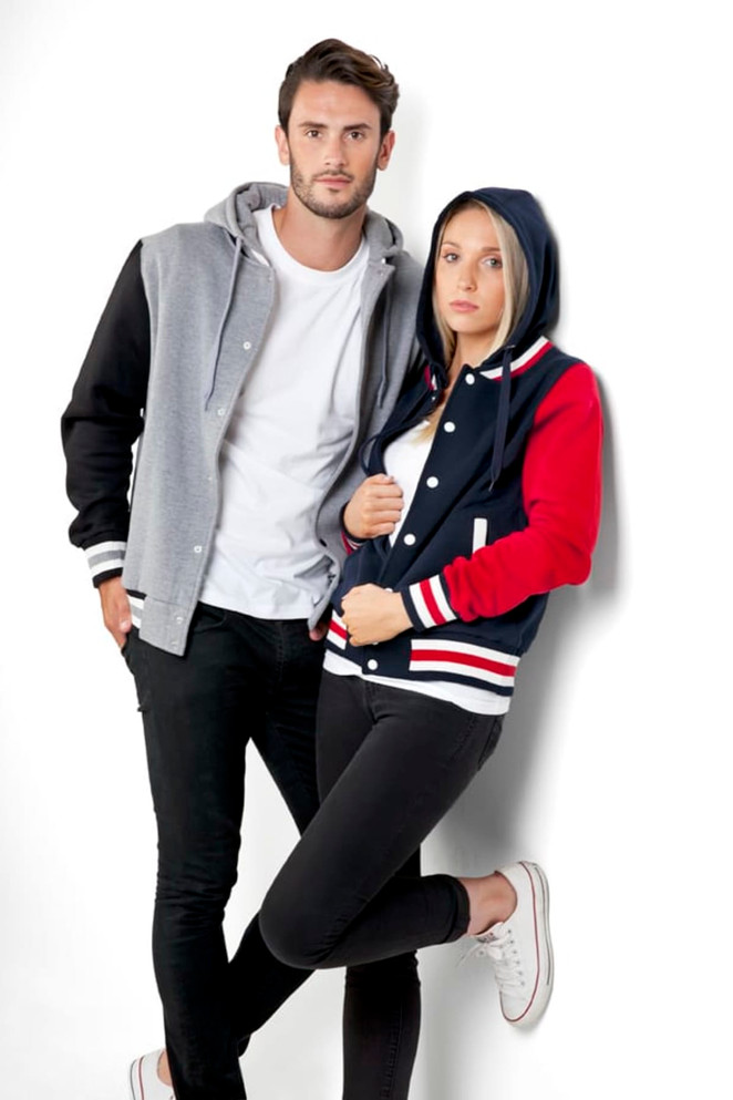 A women's varsity jacket in navy, red, and white, featuring a hood, paired with a grey jacket on a model.
