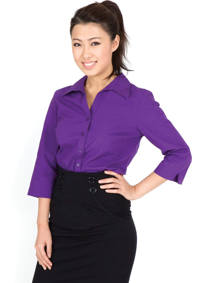 A purple women's 3/4 sleeve button-up shirt, styled with a black skirt. The shirt features a collar and buttons.