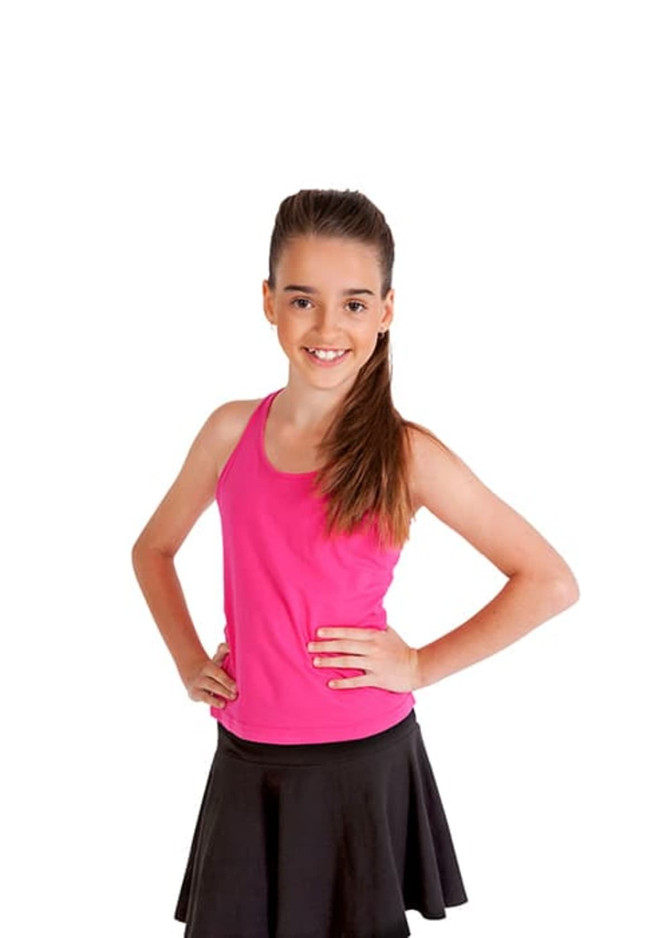 A girl wearing a bright pink singlet and a black skirt stands with her hands on her hips, smiling.