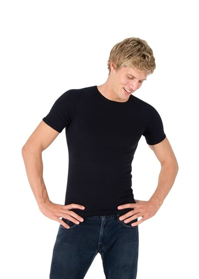A black men's spandex T-shirt is displayed on a model, who is wearing dark jeans and posing with hands on hips.