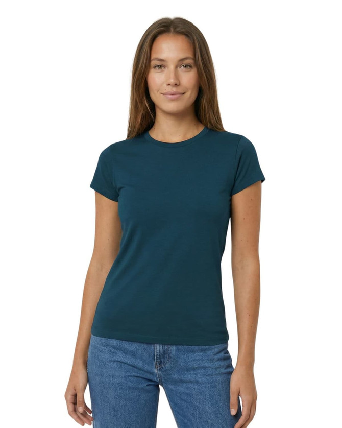 A fitted women's T-shirt in a soft teal colour displayed on a model, paired with grey sweatpants. The shirt features a logo.