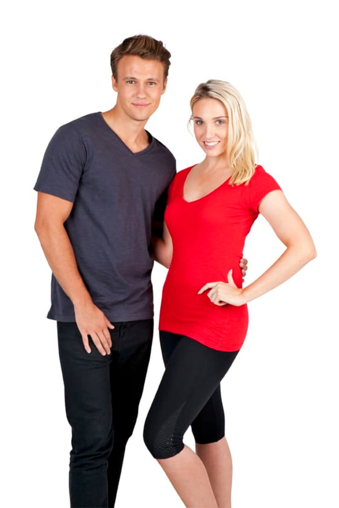A man in a grey v-neck t-shirt and a woman in a red v-neck t-shirt, both with casual attire.