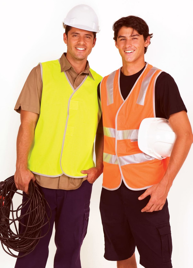 A yellow and an orange work vest with reflective tape, worn by two men in hard hats holding cables.