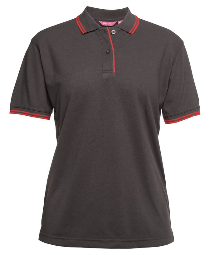 A ladies' polo shirt in dark grey with red contrast detailing on the collar and sleeves, featuring a logo.