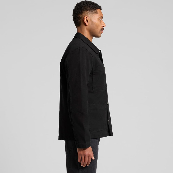 A black canvas chore jacket featuring a collar and buttons, seen from the side on a model.