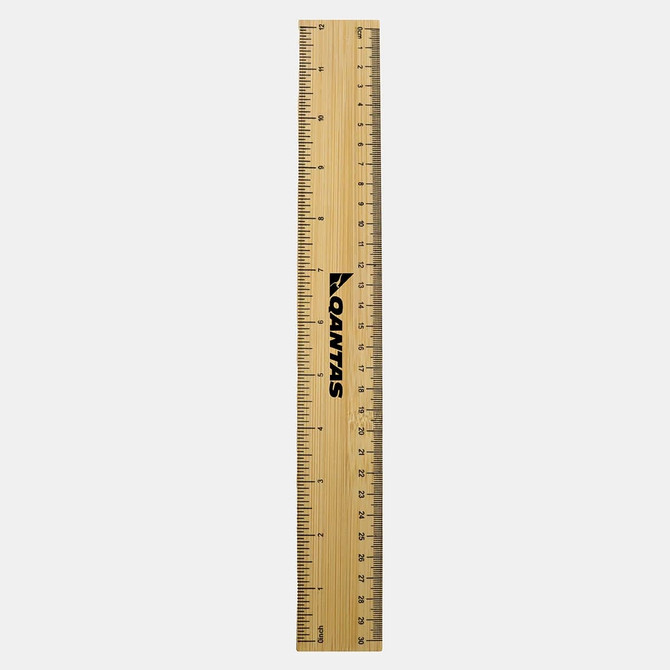 A bamboo ruler featuring metric and imperial measurements. It has a branding logo and a natural wood finish.