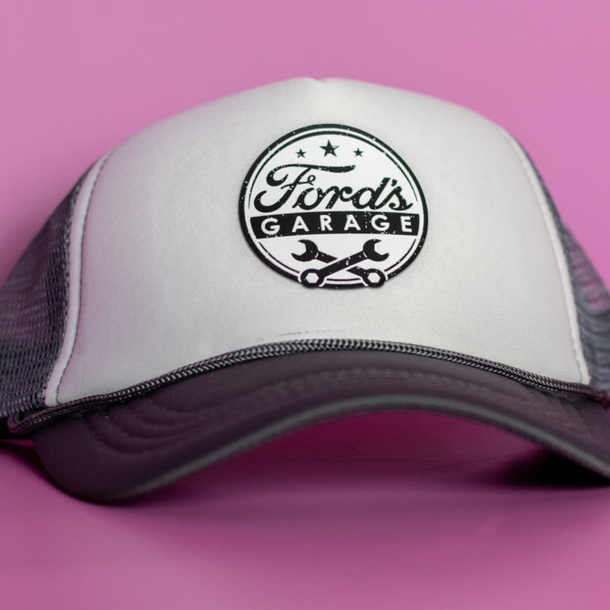 A cap featuring a white front with a grey mesh back and a logo.