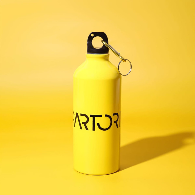 A drink bottle in bright yellow with a black top and a keyring attachment, featuring a logo.