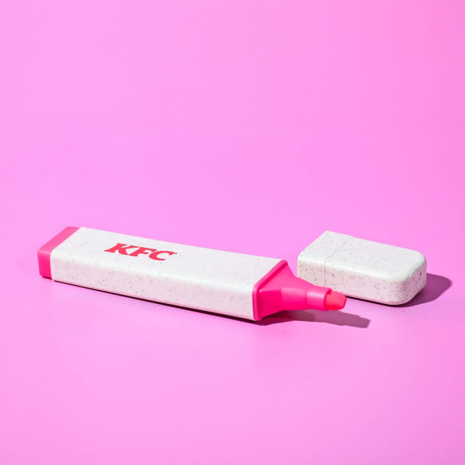 A pink eco-friendly highlighter with a white speckled casing and a removable cap, featuring a logo.