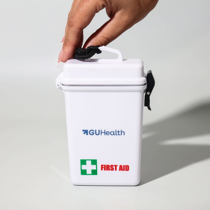 A white waterproof first aid kit with a black handle and a green cross symbol. It features a logo on the front.