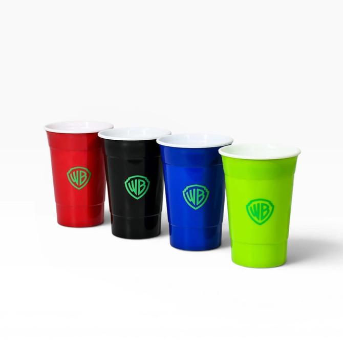 A set of four plastic party cups in red, black, blue, and green, each featuring a logo.