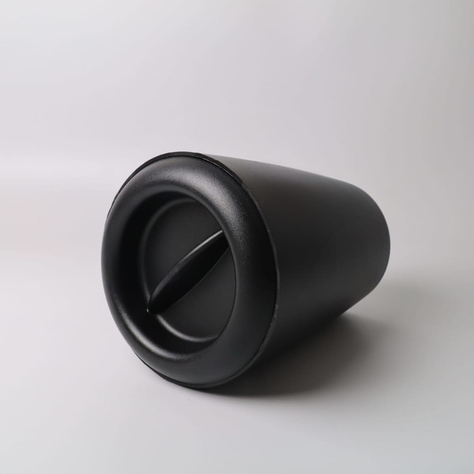 A black ice bucket with a sleek design, featuring a side opening and curved shape. It has a branding logo.